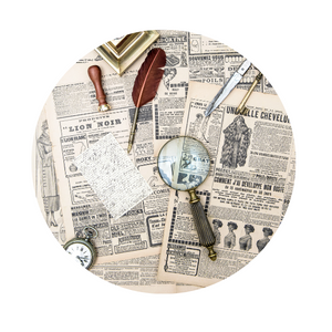 an old newspaper with a magnifying glass, a quill pen and other items