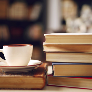 pile of books with mug